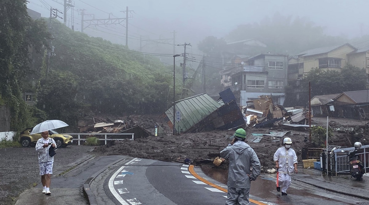 In this photo taken and provided by Satoru Watanabe, a road is covered by mud and debris following heavy rain in Atami city, Shizuoka prefecture, Saturday, July 3, 2021. (Satoru Watanabe via AP)