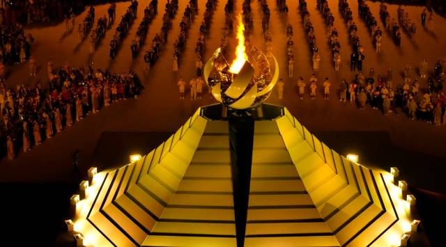 The Olympic flame burns during the opening ceremony in the Olympic Stadium at the 2020 Summer Olympics. (AP)