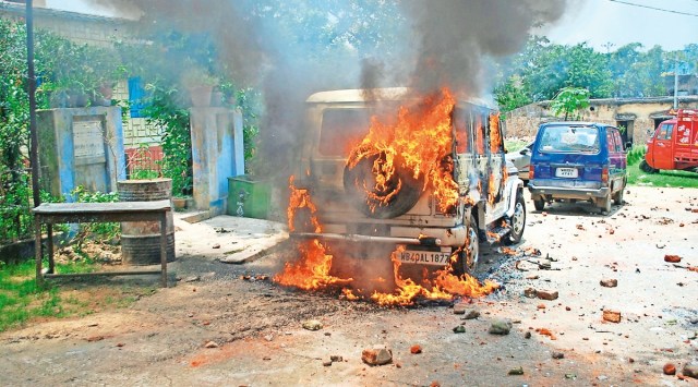 A police vehicle that was set on fire by local residents in Asansol’s Barakar area on Tuesday. (Photo: PTI)