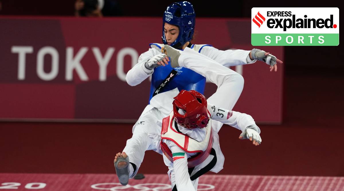 Iran's Nahid Kiyani, front, attacks Kimia Alizadeh Zonoozi, of the Refugee Olympic Team, during the women's 57kg match at the 2020 Summer Olympics, Sunday, July 25, 2021, in Tokyo, Japan. (AP Photo/Themba Hadebe)