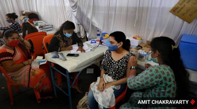 A woman gets a shot of a Covid-19 vaccine. (Express Photo by Amit Chakravarty)