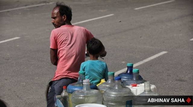 A man and his son carry cans of water home (Express Photo: Abhinav Saha, Representational)