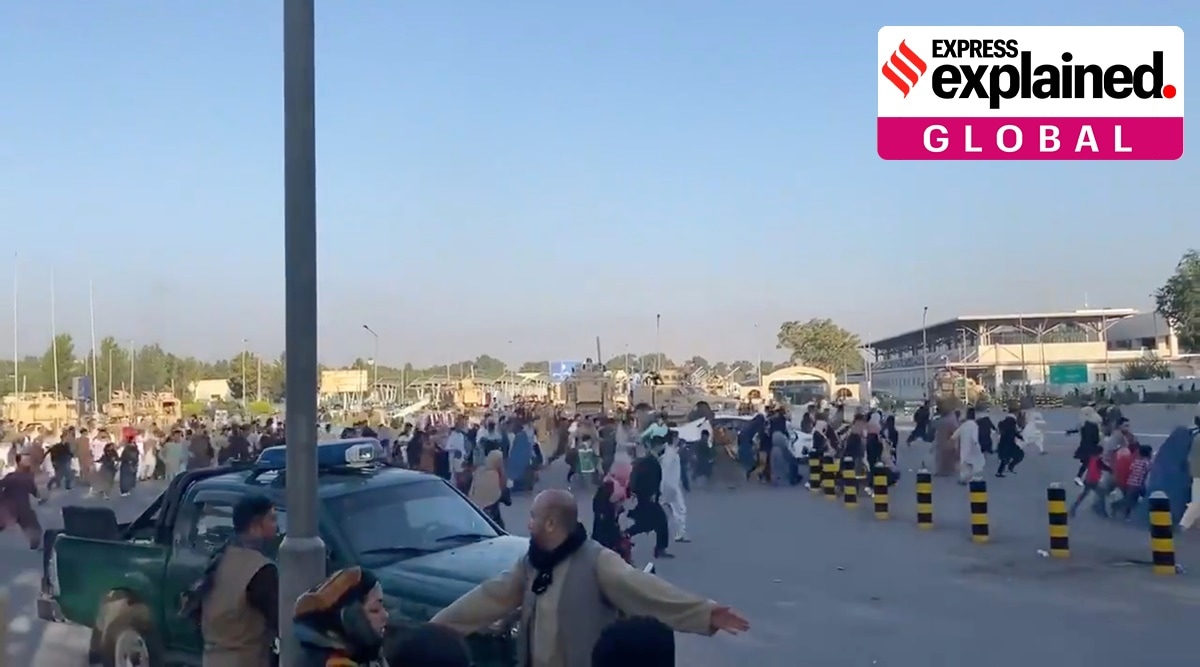 A horde of people run towards the Kabul Airport Terminal, after Taliban insurgents took control of the presidential palace in Kabul (Reuters)