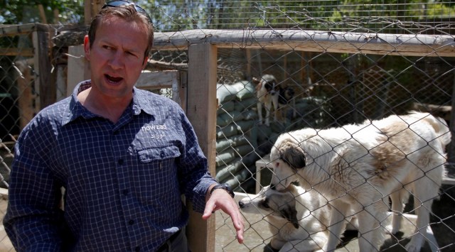 Pen Farthing, founder of British charity Nowzad, an animal shelter, stands in front of a cage on the outskirts of Kabul May 1, 2012 | Reuters