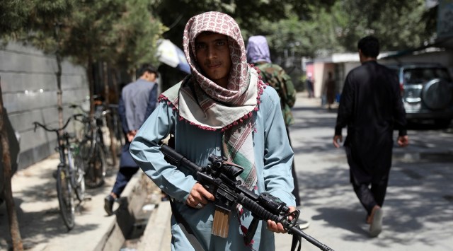 A Taliban fighter stands guard at a checkpoint in the Wazir Akbar Khan neighborhood in the city of Kabul, Afghanistan, Sunday, Aug. 22, 2021. (AP)