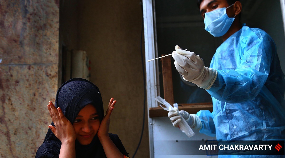A girl reacts during a RT-PCR testing in Mumbai.
(Express Photo by Amit Chakravarty/File)