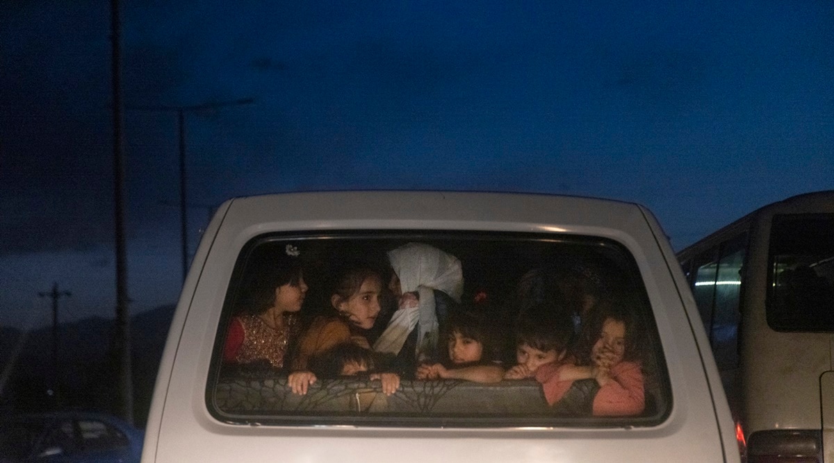 Children ride in the back of a vehicle to the Hamid Karzai International Airport in Kabul on Saturday. (Photo: The New York Times)