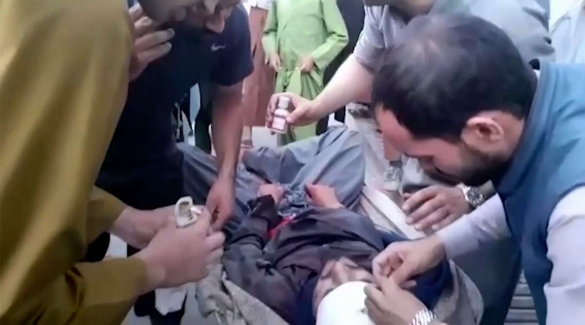 In this frame grab from video, people attend to a wounded man near the site of a deadly explosion outside the airport in Kabul, Afghanistan. (AP)