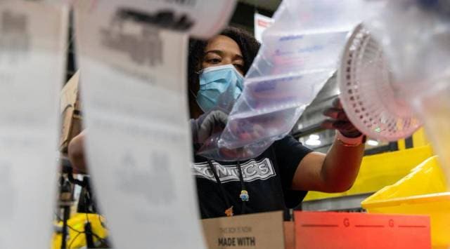 A worker fulfills orders at an Amazon fulfillment center on Prime Day in Raleigh, North Carolina, U.S., on Monday, June 21, 2021. Amazon.com Inc.'s annual Prime Day sale, which begins Monday, arrives as the world grapples with the lingering effects of the pandemic. (Bloomberg)

