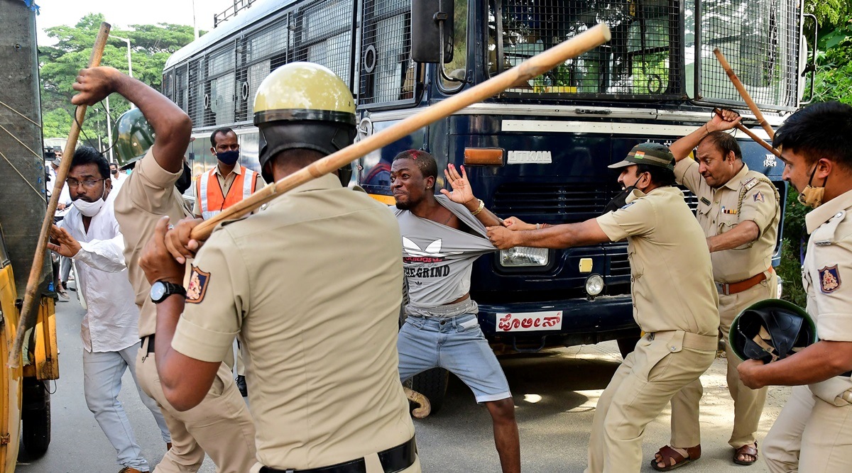 Police wield their batons against a demonstrator during a protest after the death of Joel Shindani Malu, a Congolese man, in Bengaluru. (Reuters)