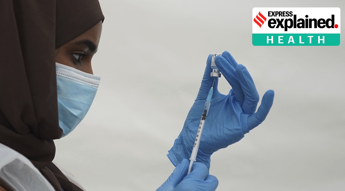 An NHS worker prepares a Covid vaccination jab at a pop-up vaccination centre during a four-day vaccine festival in Langdon Park, east London, Saturday July 31, 2021.  The authorities are implementing a program of short term pop-up vaccination sites in an attempt to prompt people to get the jab. (Kirsty O'Connor/PA via AP)