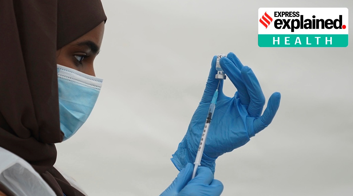An NHS worker prepares a Covid vaccination jab at a pop-up vaccination centre during a four-day vaccine festival in Langdon Park, east London, Saturday July 31, 2021.  The authorities are implementing a program of short term pop-up vaccination sites in an attempt to prompt people to get the jab. (Kirsty O'Connor/PA via AP)
