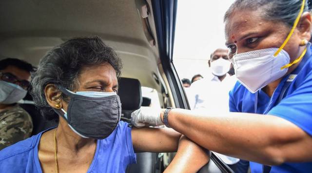 A health worker administers a dose of the COVID-19 vaccine to a person at a drive-in vaccination centre, at MGM Hospital, in Chennai. (PTI)