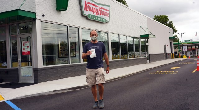 Joe Caramagna with his daily free Krispy Kreme doughnut in Maywood, New Jersey. (Photo: The New York Times)