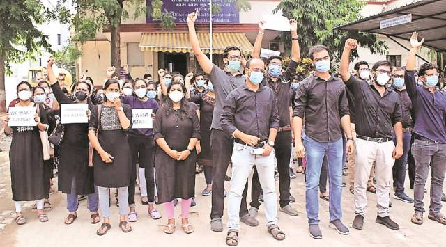 Intern doctors at SSG hospital continue their protest wearing black clothes on Friday in Vadodara. (Express)