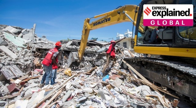 Members of a rescue and protection team clean debris from a house after a 7.2 magnitude earthquake in Les Cayes, Haiti. (REUTERS/Ralph Tedy) 