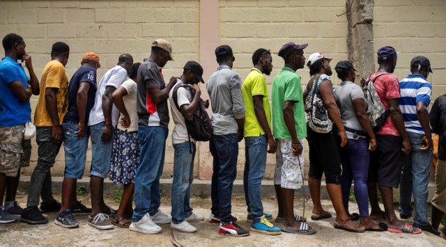 People affected by the August 14 earthquake wait for food provided by the World Food Program, at a school in Port Salut, Haiti August 24, 2021. (Reuters)