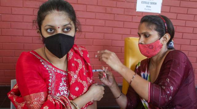 A health worker administers a dose of COVID-19 vaccine to a beneficiary at a vaccination centre in Gurugram, Wednesday, August 4, 2021. (PTI Photo)