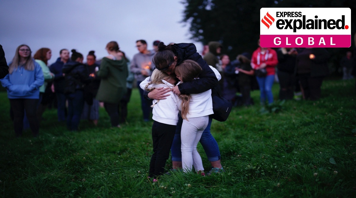 Plymouth: A woman embraces two children during a vigil for the victims of the Keyham mass shooting in Plymouth, England. (AP)