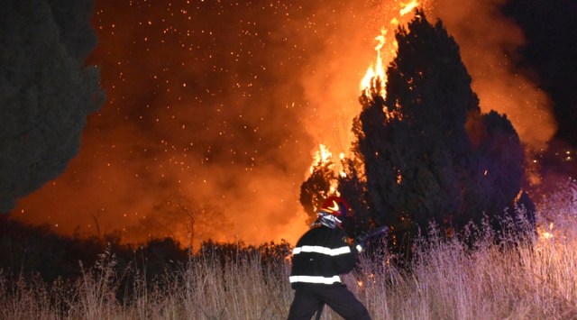 In this photo released by the Italian Firefighters, a view of a fire near Petralia Soprana, in the upper Madonie, near Palermo, Sicily, Italy, in the early hours of Wednesday, Aug. 11, 2021, as many wildfires continue plaguing the region. (AP Photo)
