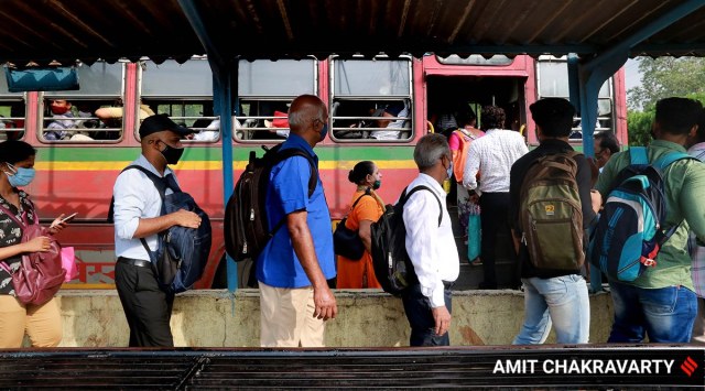 Commuters stand in queue at a bus stand amid the Covid-19 pandemic. (Express Photo: Amit Chakravarty, File)