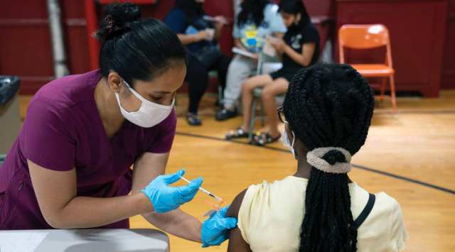 A dose of the Pfizer coronavirus vaccine is administered in the Bronx on Aug. 8, 2021. (James Estrin/The New York Times)