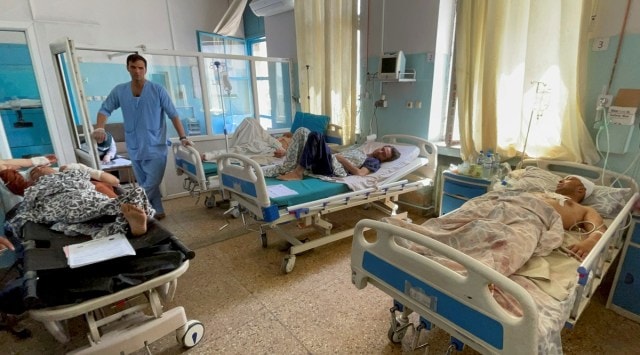 Wounded Afghan men receive treatment at a hospital after yesterday's explosions outside airport in Kabul, Afghanistan on Aug. 27, 2021. (Reuters)