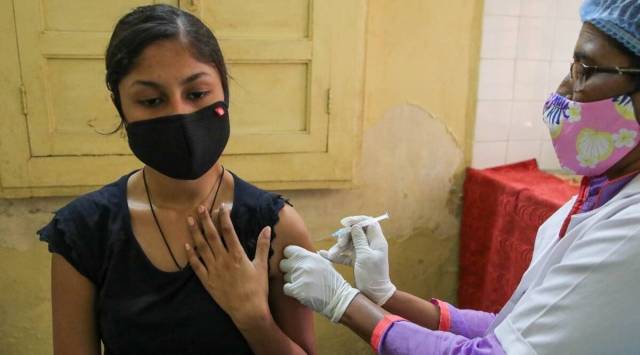 A woman gets a shot of a Covid-19 vaccine in Pune. (Express Photo: Ashish Kale)