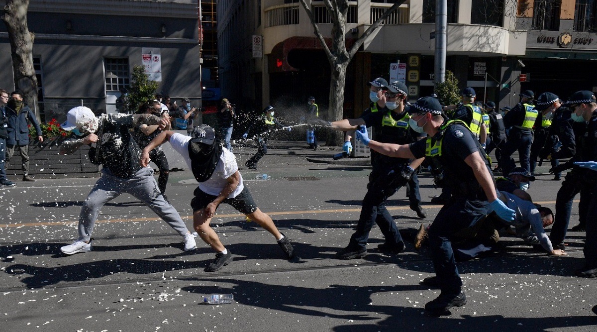 Police use pepper spray on protesters during an anti-lockdown protest in Melbourne. (AP)