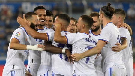 Real Madrid's Karim Benzema, left, celebrates with team mates after scoring his side's opening goal during a Spanish La Liga soccer match between Alaves and Real Madrid at the Mendizorroza stadium in Vitoria, Spain, Saturday, Aug. 14, 2021. (AP Photo/Alvaro Barrientos)