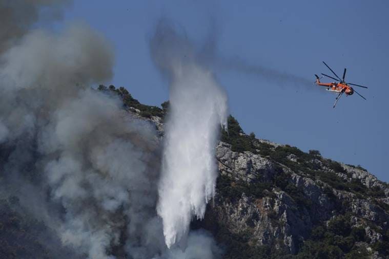 Wildfires rampage in Greek forests, cut large island in half