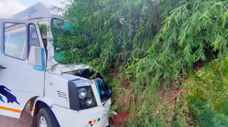 The bus in which the team of IT officers and police were traveling, on the highway side after the accident, in Surendranagar on Tuesday. (Express photo)