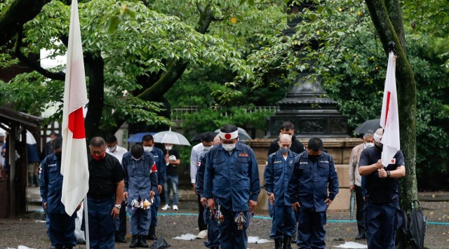 Members of a right-wing group pay silent tribute during their visit to Yasukuni Shrine on the 76th anniversary of Japan's surrender in World War Two, amid the coronavirus disease (COVID-19) pandemic, in Tokyo, Japan. (REUTERS/Issei Kato)