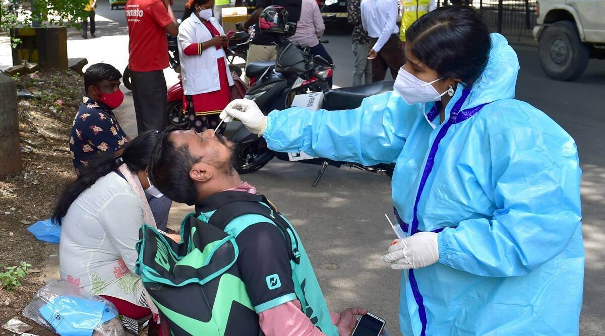 A medic collects samples from e-commerce and food delivery personnel for Covid-19 testing in Bengaluru. (Photo: PTI)