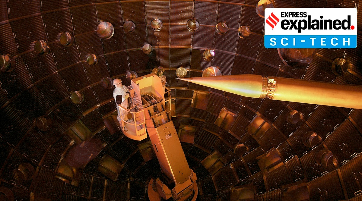 The interior of the National Ignition Facility target chamber. The service module carrying technicians can be seen on the left. The target positioner, which holds the target, is on the right.