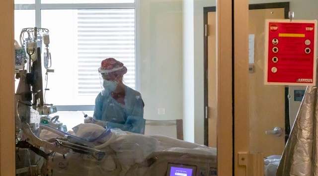 In this Aug. 19 photo, a staff member treats a patient at the Critical Care Unit at Asante Three Rivers Medical Center in Grants Pass, Oregon. (AP photo)