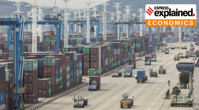 Containers sit stacked next to gantry cranes as trucks operate at the Port of Ningbo-Zhoushan in Ningbo, China. (Bloomberg Photo: Qilai Shen)