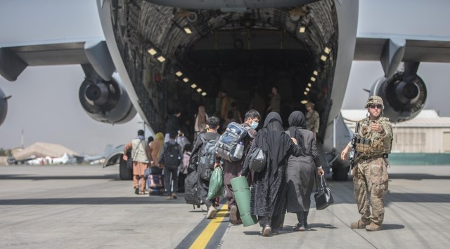 Afghan families board a US Air Force aircraft during evacuation at Hamid Karzai International Airport in Kabul, Afghanistan. (Twitter/@DeptofDefense)