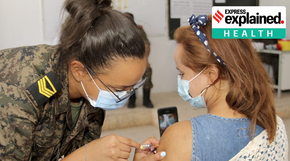 A soldier administers a dose of the Moderna Covid-19 vaccine to a woman in Tunis. (AP Photo: Hassene Dridi, File)