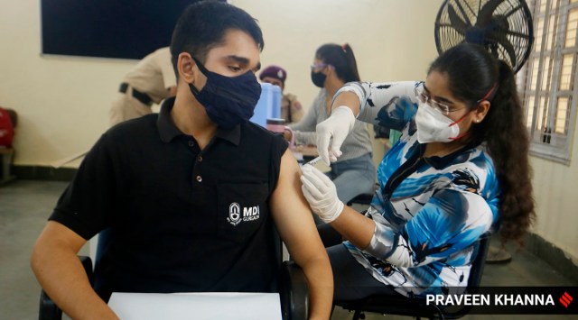 Beneficiary takes shot of the Covid-19 vaccine at a vaccination centre in New Delhi. (Express Photo by Praveen Khanna)