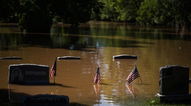 Headstones at a cemetery that flooded are seen in Somerville, N.J. Thursday, Sept. 2, 2021. A stunned U.S. East Coast faced a rising death toll, surging rivers, tornado damage and continuing calls for rescue Thursday after the remnants of Hurricane Ida walloped the region with record-breaking rain, drowning more than two dozen people in their homes and cars. (AP Photo/Eduardo Munoz Alvarez)