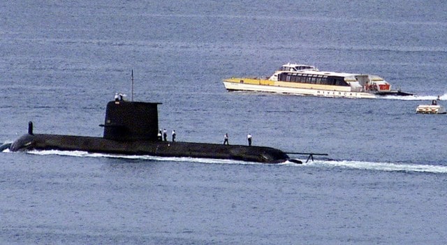 A Rivercat ferry passes by the Royal Australian Navy's Collins-class submarine HMAS Waller as it leaves Sydney Harbour on May 4, 2020. The Australian government has considered extending the life of the Collins class as it examines the fate of its next-generation sub program | Reuters file Photo