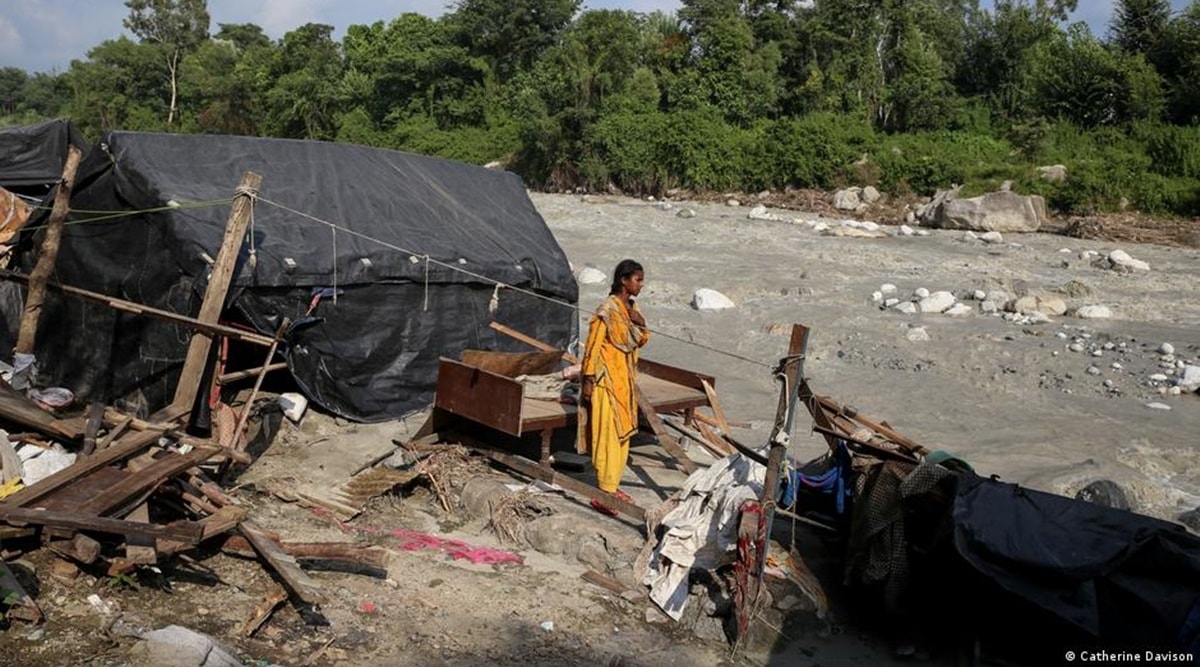 Reena Bhalekar stands in the location where her house was before the floods swept it away. All that remains is her bed (Catherine Davison)