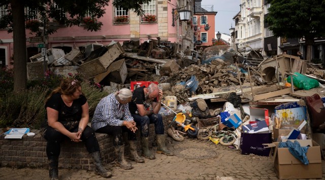 People rest from cleaning up the debris of the flood disaster in Bad Neuenahr-Ahrweiler, Germany in July this year. (AP)