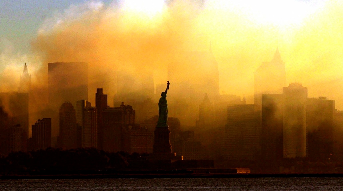 In this Saturday, Sept. 15, 2001 photo, the Statue of Liberty stands in front of a smoldering lower Manhattan at dawn, seen from Jersey City, NJ. (AP)