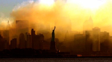 In this Saturday, Sept. 15, 2001 photo, the Statue of Liberty stands in front of a smoldering lower Manhattan at dawn, seen from Jersey City, NJ. (AP)