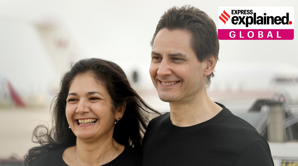 Michael Kovrig embraces his wife Vina Nadjibulla, left, after arriving at Pearson International Airport in Toronto (AP)