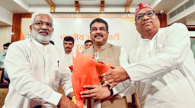 Union Minister and BJP's U P election incharge Dharmendra Pradhan being welcomed by UP BJP President Swatantra Dev Singh (L) and Nishad Party President Sanjai Nishad (R) before a press conference, in Lucknow. (PTI Photo)