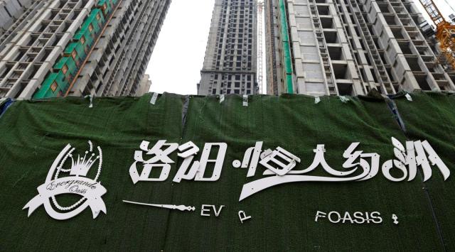 A peeling logo of the Evergrande Oasis, a housing complex developed by Evergrande Group, is pictured outside the construction site where the residential buildings stand unfinished, in Luoyang, China September 16, 2021. Picture taken September 16, 2021. (REUTERS)