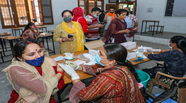 A medic administers a dose of COVID-19 vaccine to a beneficiary in Jammu. (PTI)
